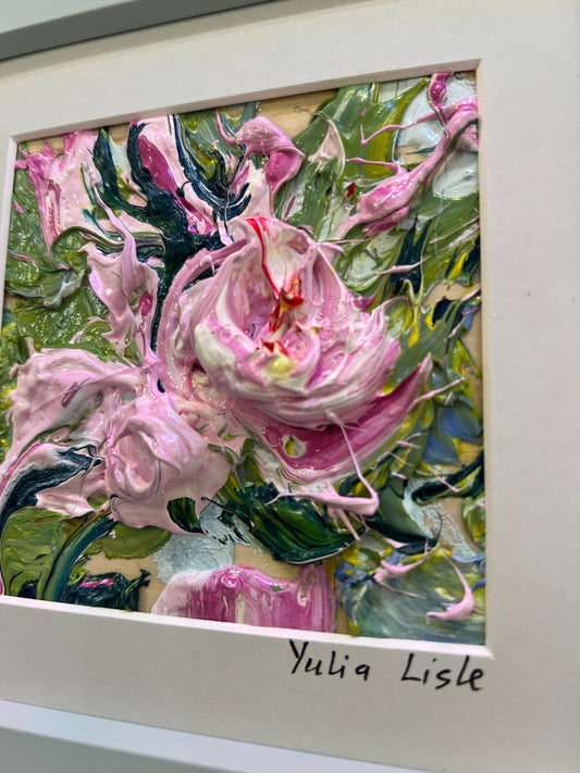 Small framed original impasto oil painting by Yulia Lisle featuring a delicately textured soft pink flower surrounded by fresh green foliage, created with expressive palette knife strokes and richly layered oil paint. Artwork by Yulia Lisle and available at The Acorn Gallery in Pocklington. Shop online or call us on 01759 307652.