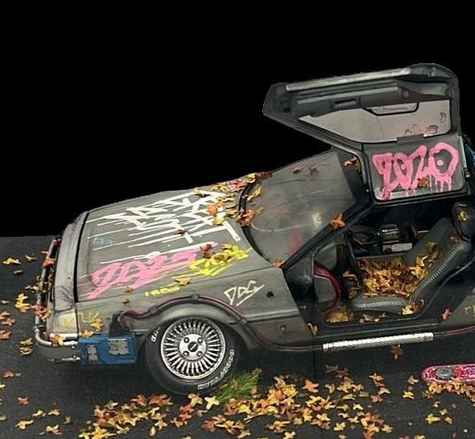 Die-cast 1:18 scale model of the Delorean time machine from Back to the Future movies. Created by artist JJ Adams from his 'Stolen Recovered' Car Collection series. Available from The Acorn Gallery in Pocklington. Visit us or shop online or call us on 01759 307652.