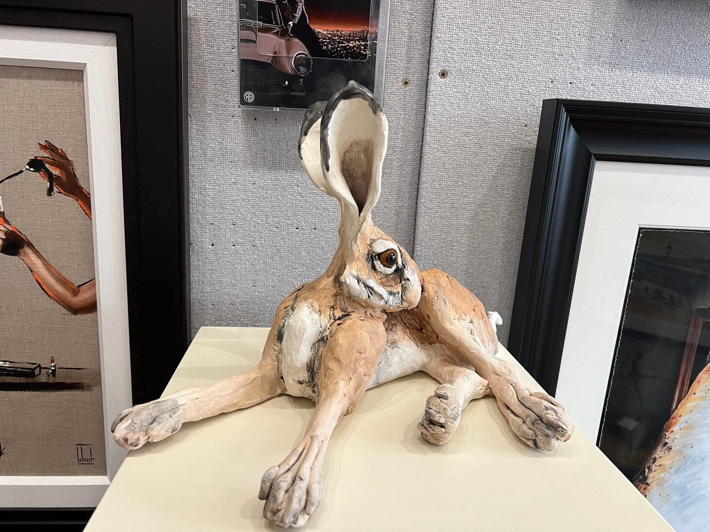 Louise Brown ceramic sculpture of a lying down hare with head turned