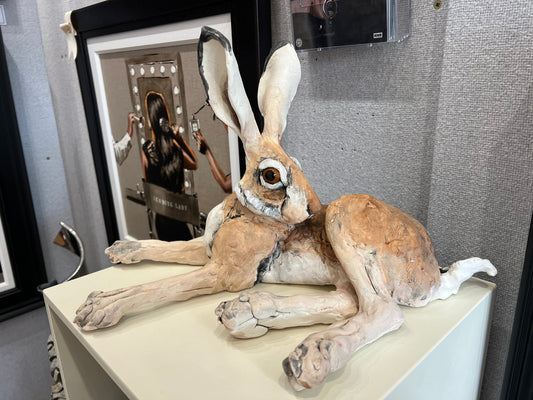 Louise Brown ceramic sculpture of lying down hare with head turned original artwork