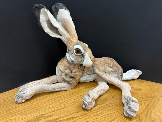 A beautiful lying down hare hand made by artist Louise Brown at The Acorn Gallery in Pocklington. Visit us or shop online. Safe UK delivery. Or call us 01759 307652.