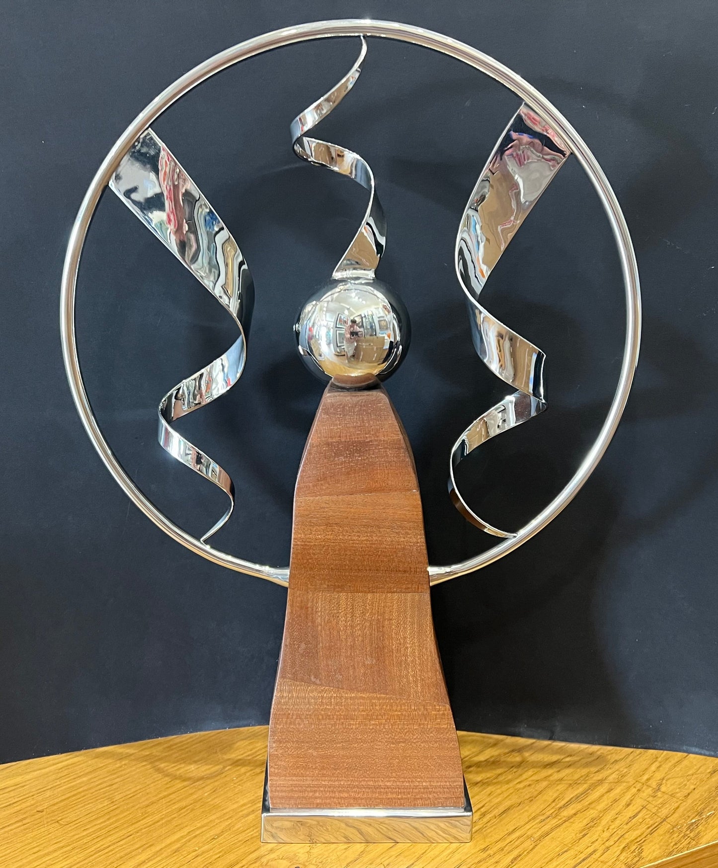 Stainless steel ring sculpture with stainless steel ribbons mounted on a beautiful mahogany pillar with a stainless steel base. Original sculpture by Lancastrian sculptor Malcolm Hull and available at The Acorn Gallery in Pocklington. Call 01759 307652.