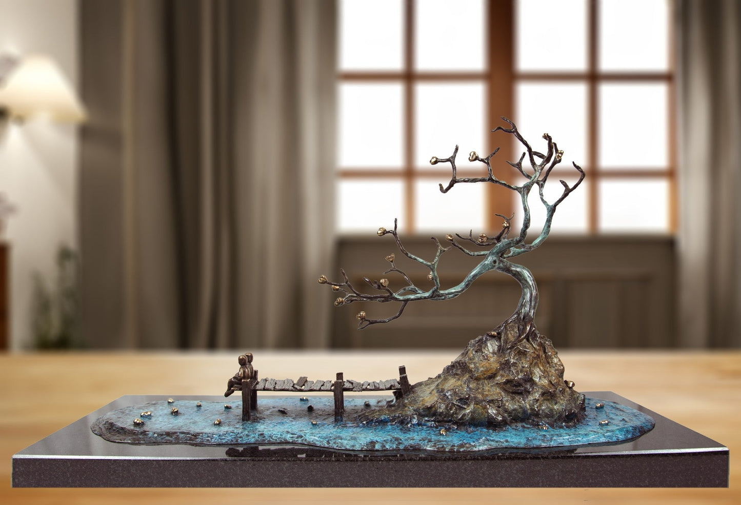Sculpture of a tree by a lake with two people sitting on a jetty. Sculpture by Mackenzie Thorpe at The Acorn Gallery in Pocklington. Call 01759 307652.