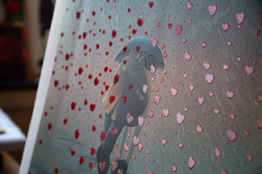 Remember When is a framed limited edition print by Middlesbrough artist Mackenzie Thorpe. It shows a couple under an umbrella walking theough a shower of falling love hearts. Available at The Acorn Gallery in Pocklington with free UK delivery. Shop online or call us on 01759 307652.