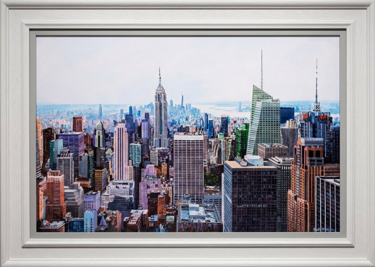 Limited edition print by Paul McIntyre, a detailed New York skyline in blue and warm tones, framed in white molding.