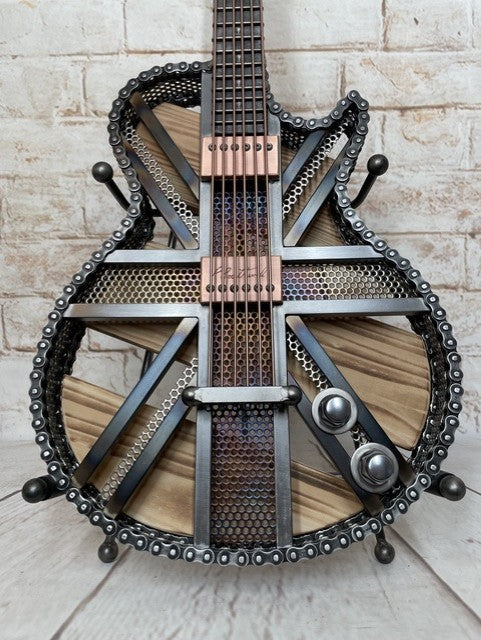 Colours Union Jack metal guitar sculpture by Paul Southwell, inspired by a Gibson Les Paul with heat-tempered iridescent metal and wood detailing