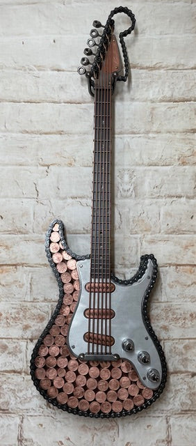 Heads and Tails metal guitar sculpture by Paul Southwell, inspired by a Fender Stratocaster and featuring British 1p and 2p coins