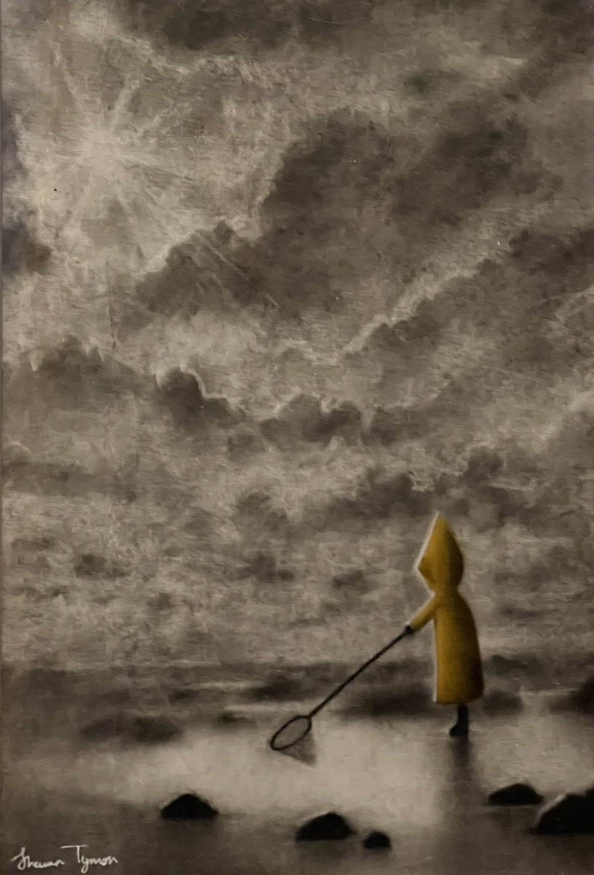 Original charcoal drawing by Shaun Tymon, depicting a child in a yellow raincoat searching a rocky shoreline with a net.