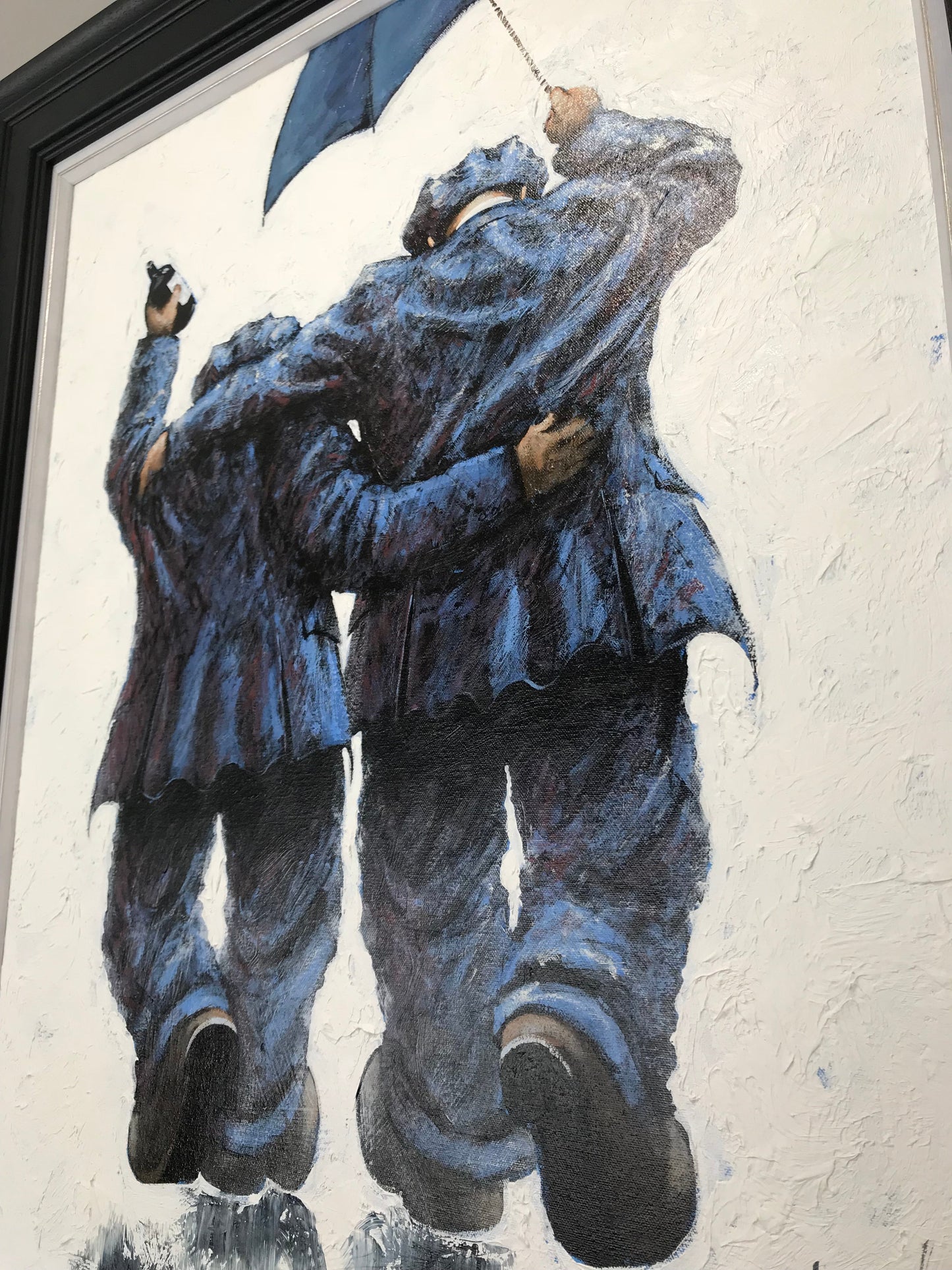 Braving The Storm oil painting by Alexander Millar depicting two men in blue coats with umbrella facing a storm, original signed artwork