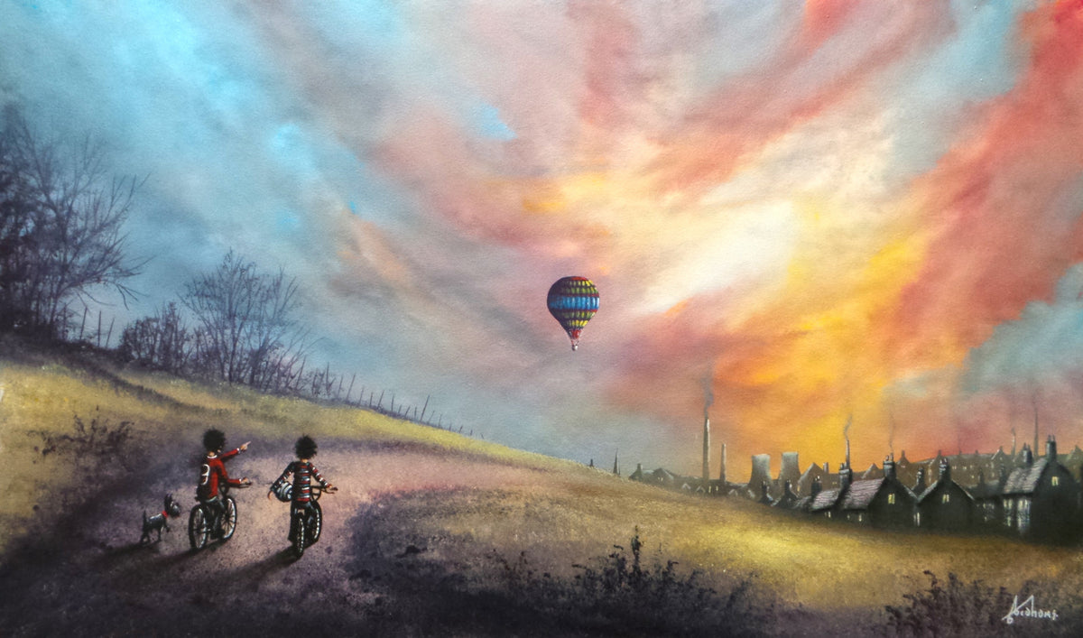 Original oil painting by Danny Abrahams, with two cyclists watching a colourful hot air balloon above a village.