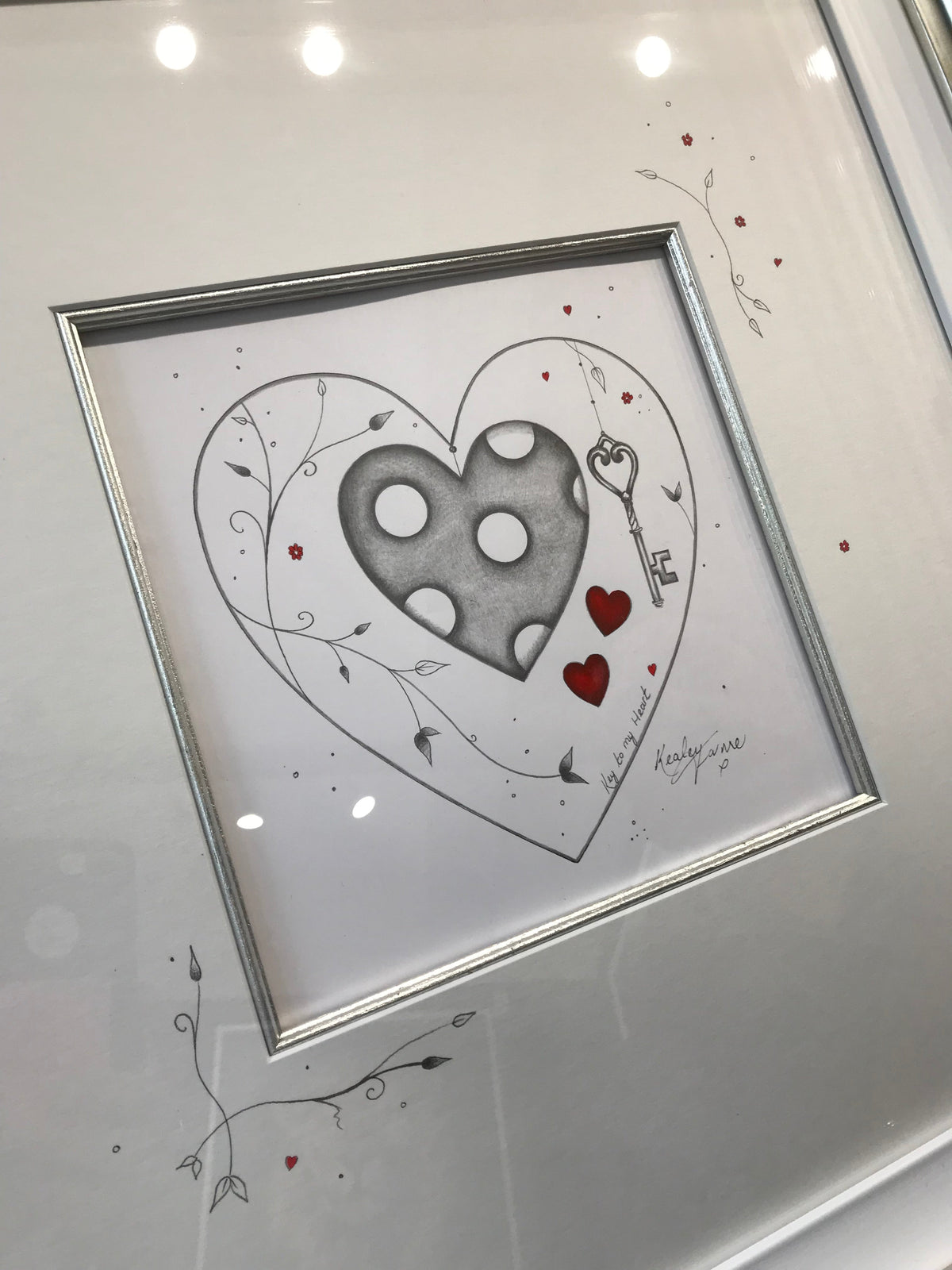 Key to My Heart Original Sketch by Kealey Farmer, pencil heart sketch with a key, red accents and embellished mount, framed in silver.