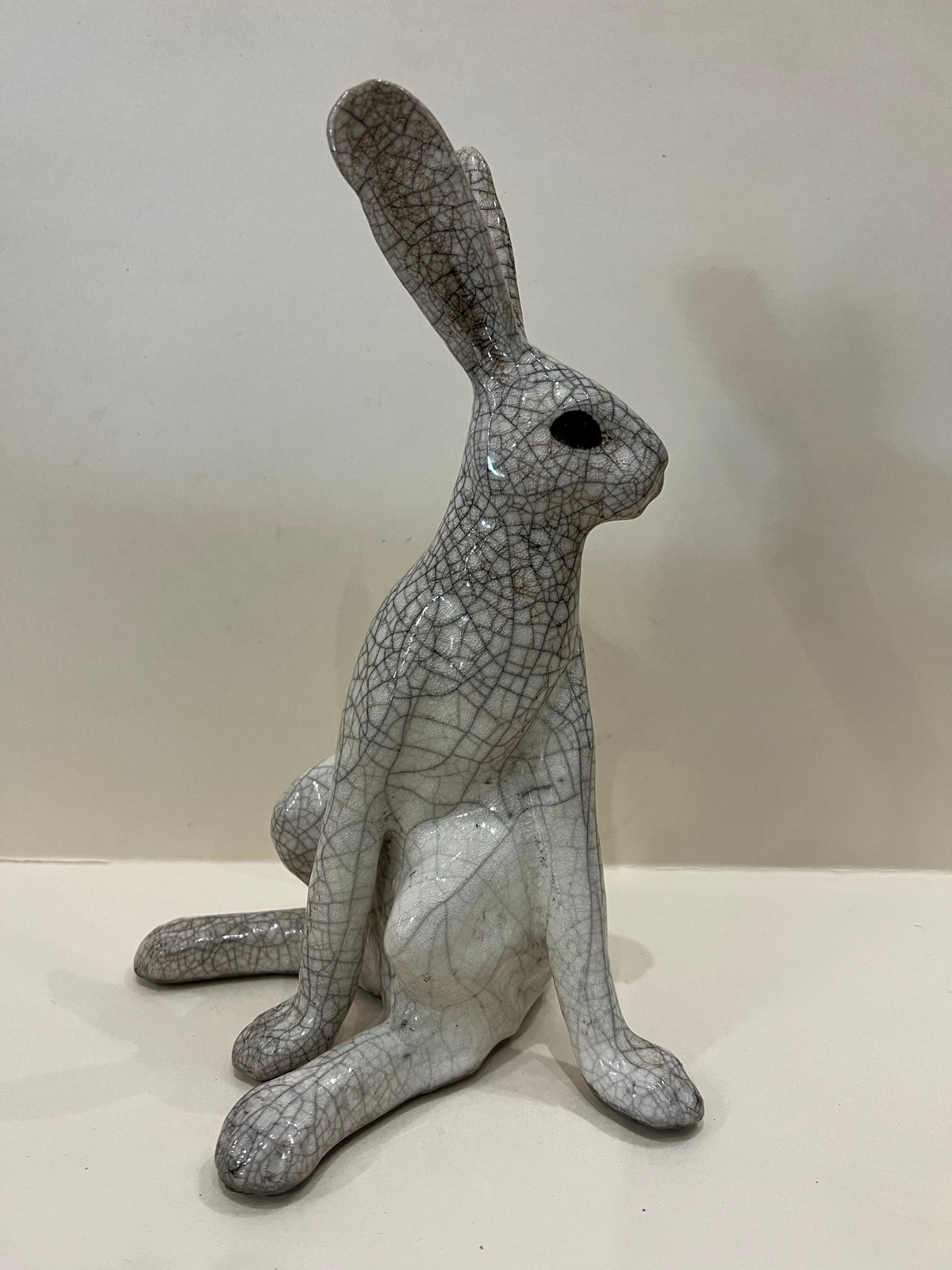 Medium Turning Hare Raku Sculpture by Paul Jenkins, grey ceramic hare with black crackle pattern and upright ears