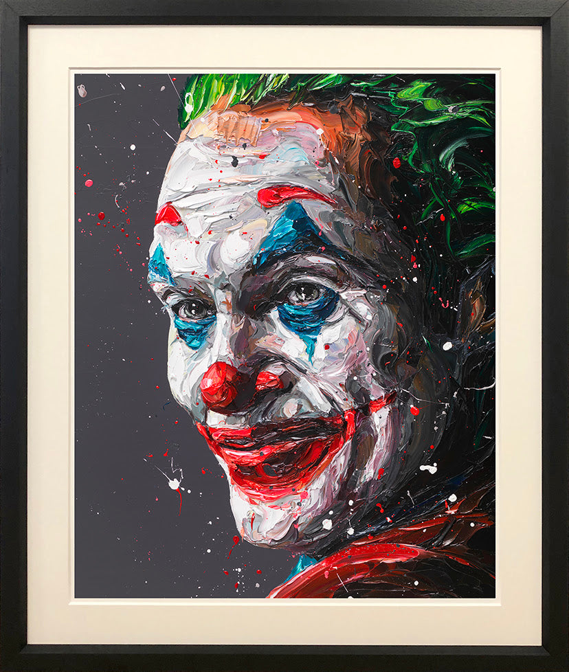 Framed Joker portrait print by Paul Oz, featuring a white face, vivid red lips, blue accents and green hair.