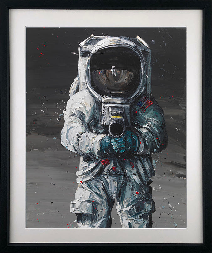 Astronaut print by Paul Oz, showing a white-suited figure against a black and grey lunar scene with red accents.