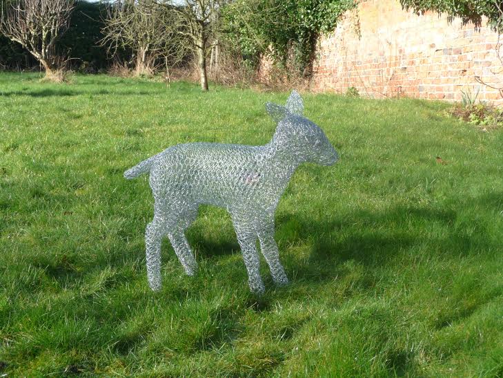 Wire sculpture of a lamb by Richard Gibson on grass outdoors