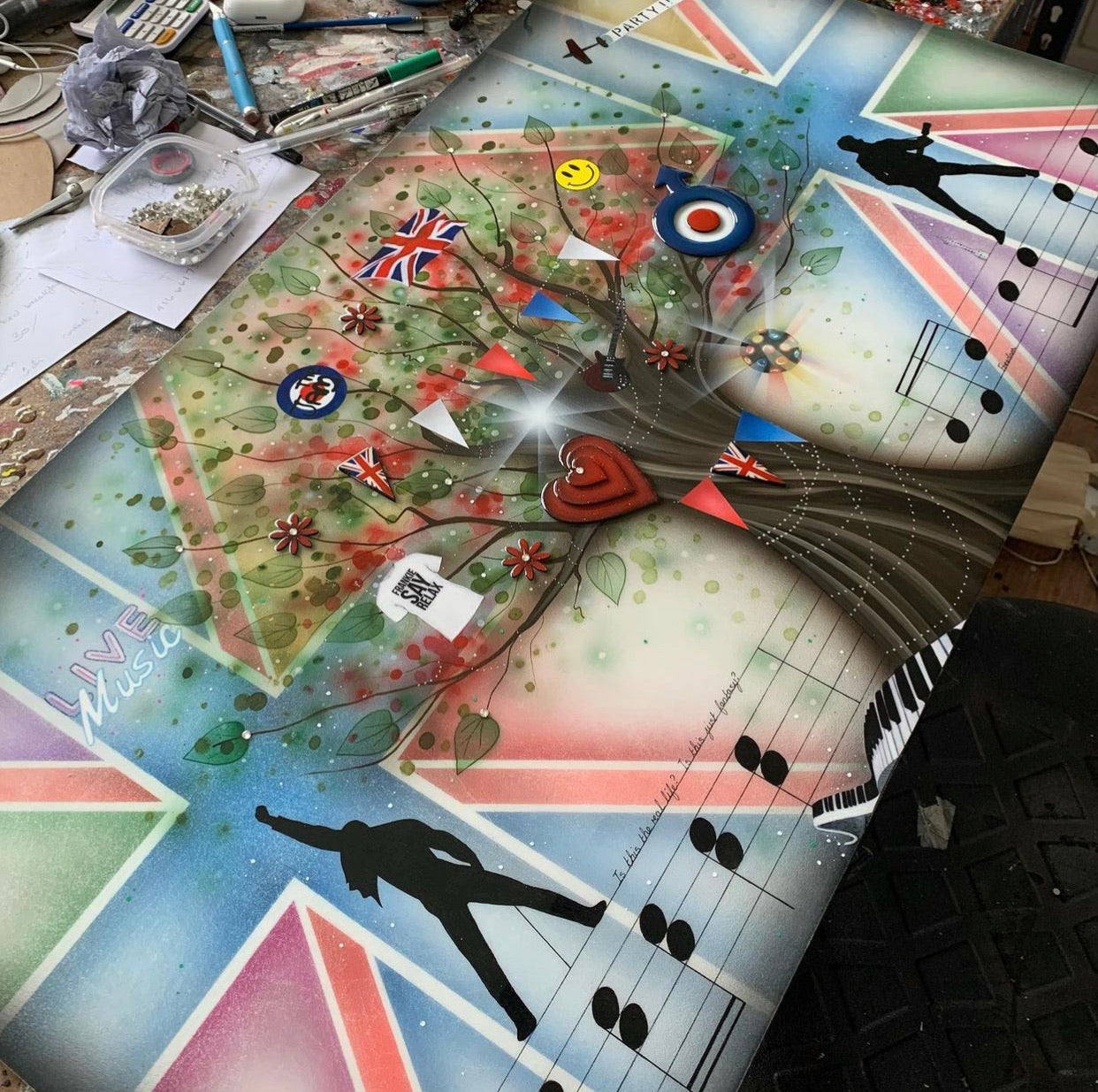 Mixed media artwork Best Of British Music by Kealey Farmer featuring British flags, music notes, and silhouettes on a Union Jack background.