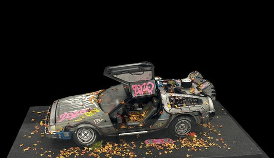 Die-cast 1:18 scale model of the Delorean time machine from Back to the Future movies. Created by artist JJ Adams from his 'Stolen Recovered' Car Collection series. Available from The Acorn Gallery in Pocklington. Visit us or shop online or call us on 01759 307652.