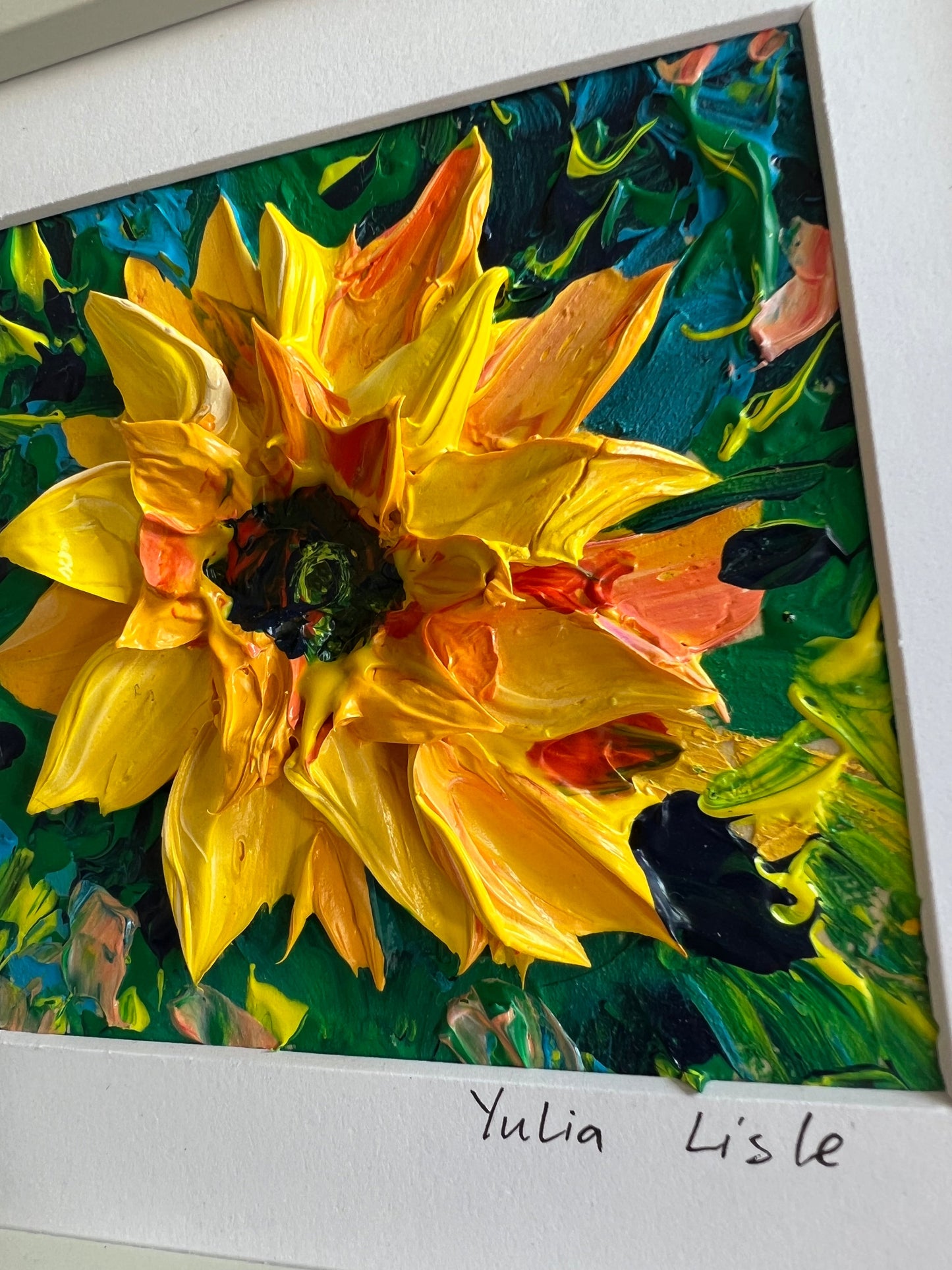 Close up of a Small freestanding framed original oil painting featuring a richly textured sunflower in vibrant yellow and golden tones, created with expressive impasto paint by Yulia Lisle available at The Acorn Gallery in Pocklington. Shop online or call us on 01759 30652. 