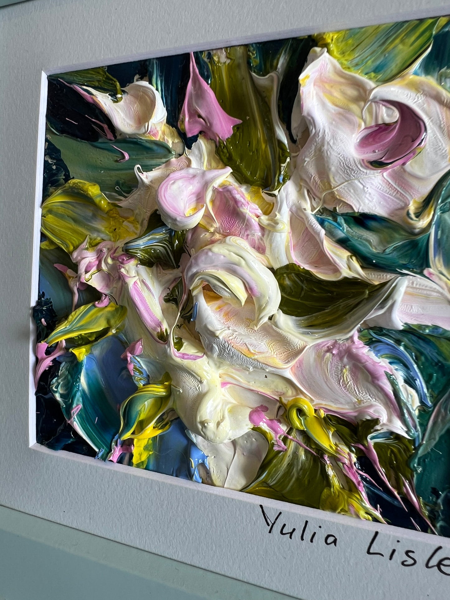 Small framed original impasto oil painting by Yulia Lisle featuring soft cream and blush flowers surrounded by rich green foliage, created with heavily textured palette knife strokes. Artwork by Yulia Lisle and available at The Acor Gallery in Pocklington where you can shop online or call us on 01759 307652. 
