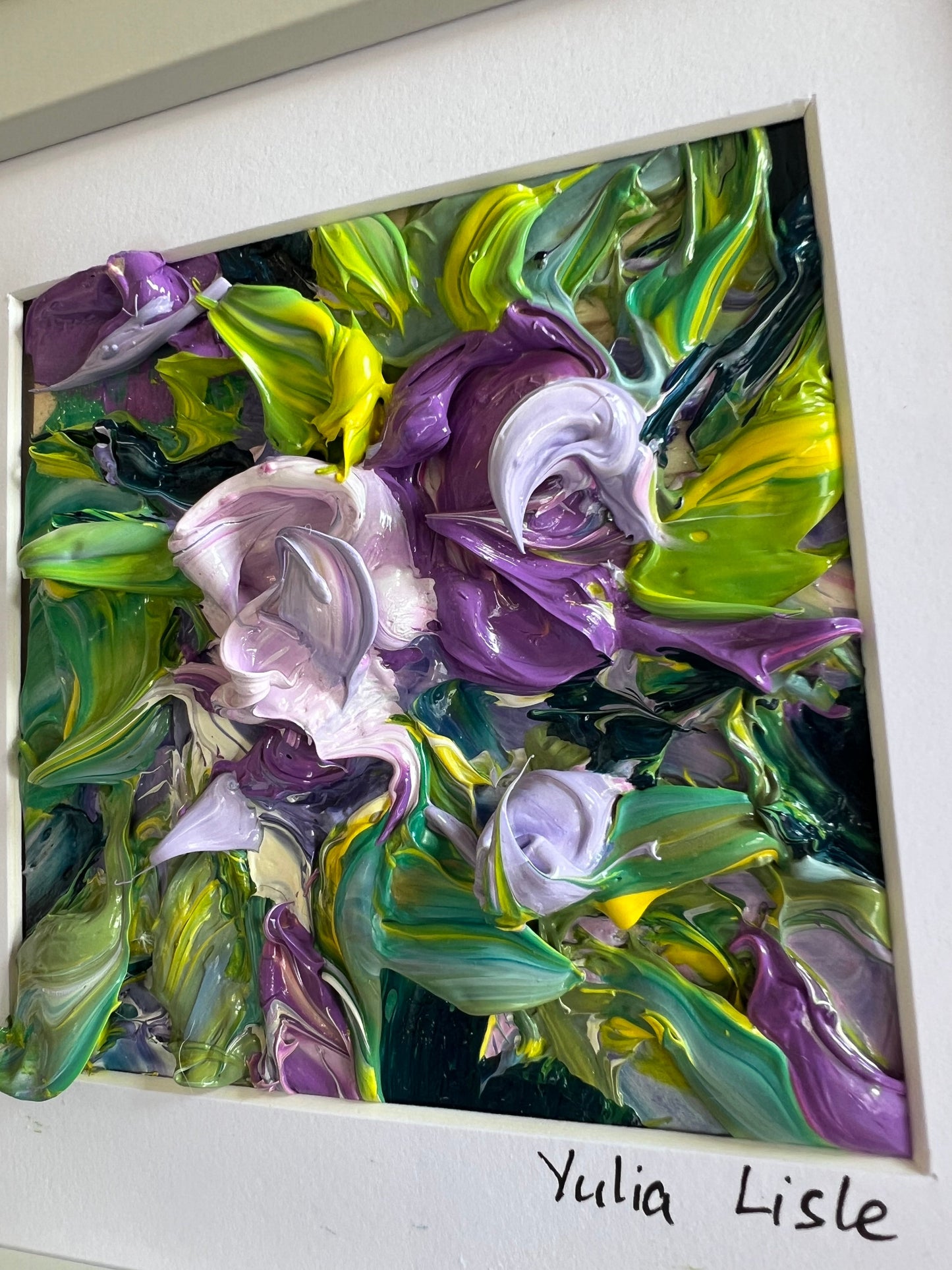 Small framed original impasto oil painting by Yulia Lisle featuring richly textured purple flowers surrounded by vibrant green foliage, created with expressive palette knife strokes and thick layers of oil paint. Artwork by Yulia Lisle and available at The Acorn Gallery in Pocklington where you can shop online or call us on 01759 307652.