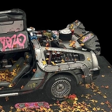 Die-cast 1:18 scale model of the Delorean time machine from Back to the Future movies. Created by artist JJ Adams from his 'Stolen Recovered' Car Collection series. Available from The Acorn Gallery in Pocklington. Visit us or shop online or call us on 01759 307652.