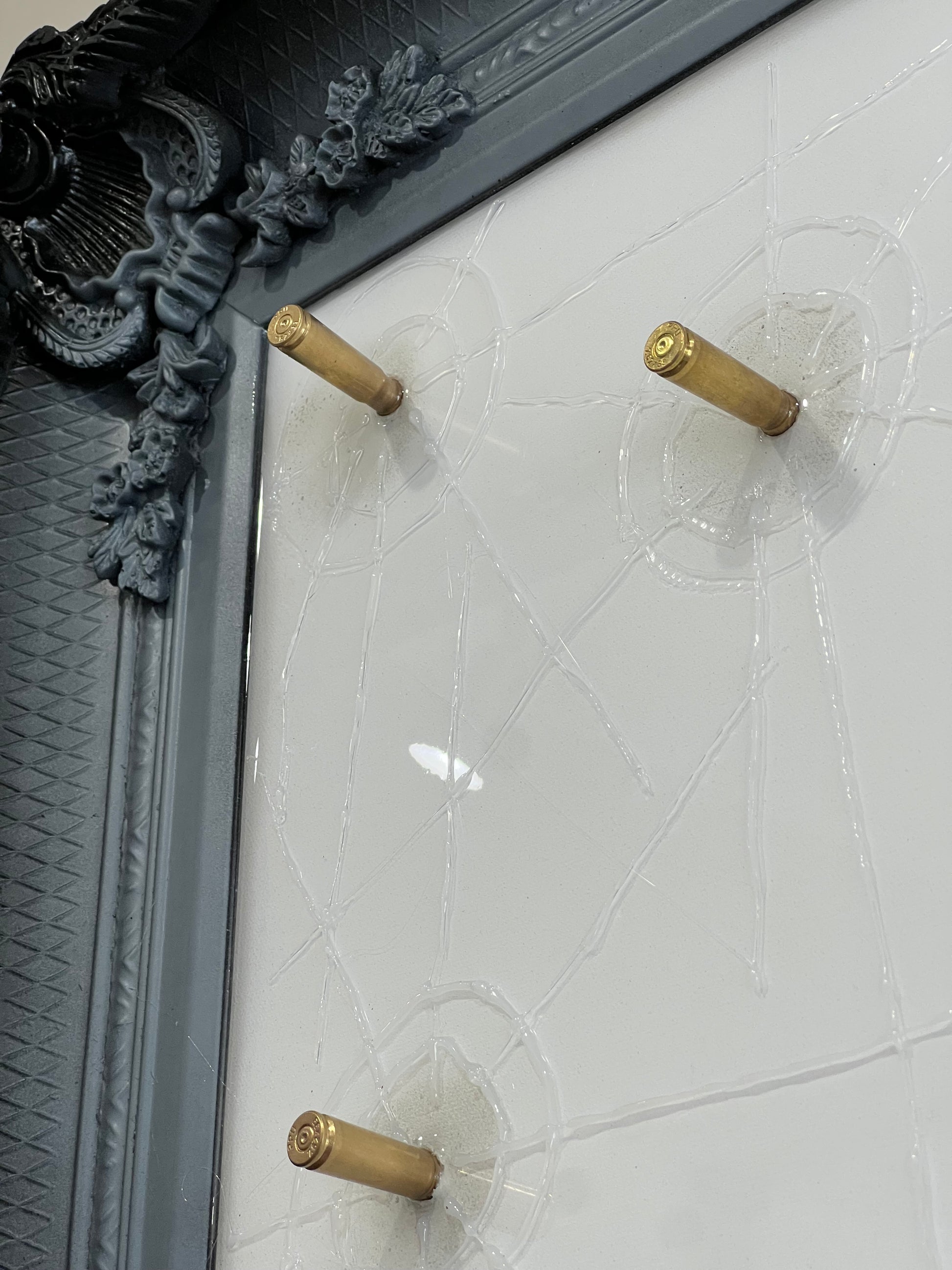 Artwork by Ghost featuring the Peaky Blinders character Tommy Shelby. It is titled Strike When Your Enemy Is Weak, and comes in a stunning black and gold ornate frame, embellished with shell casings! Shop at The Acorn Gallery, Pocklington. Buy online or call 01759 307652.