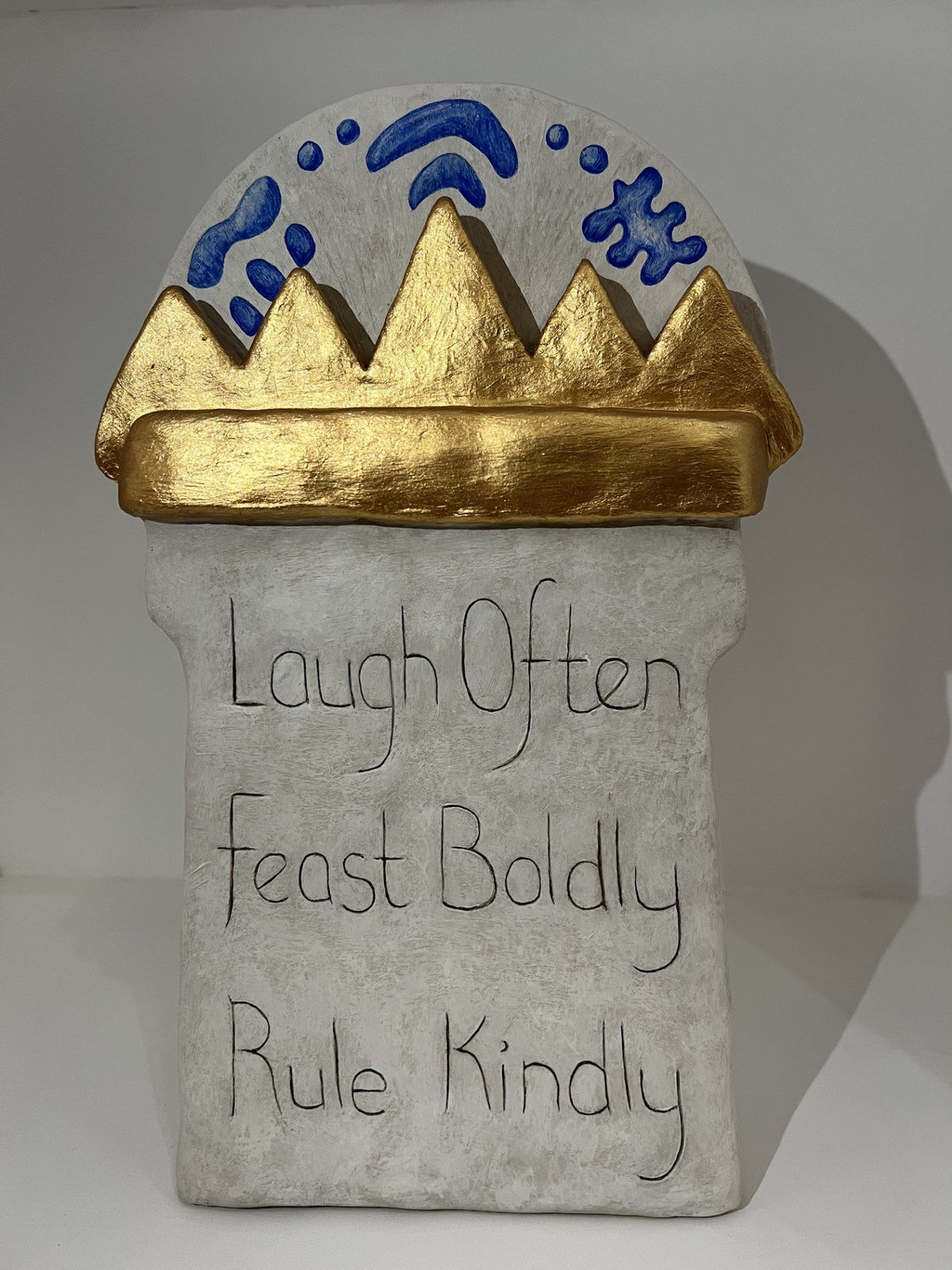 Rear of Jenny Mackenzie's Feast Boldly sculpture featuring the words Laugh Often Feast Boldly Rule Kindly.