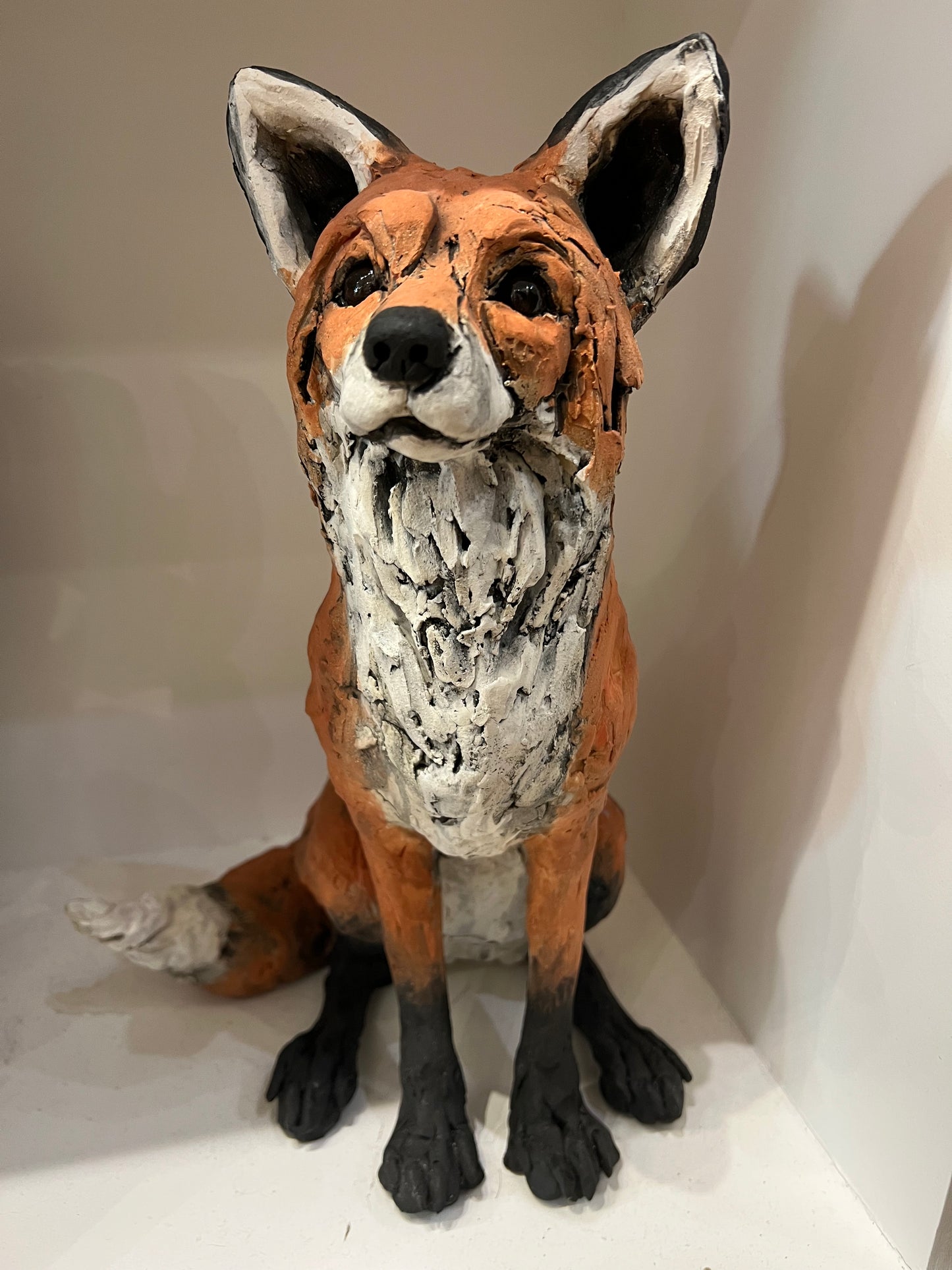Clay sculpture of a fox on a white surface by Louise Brown at The Acorn Gallery in Pocklington. Call 01759 307652. 