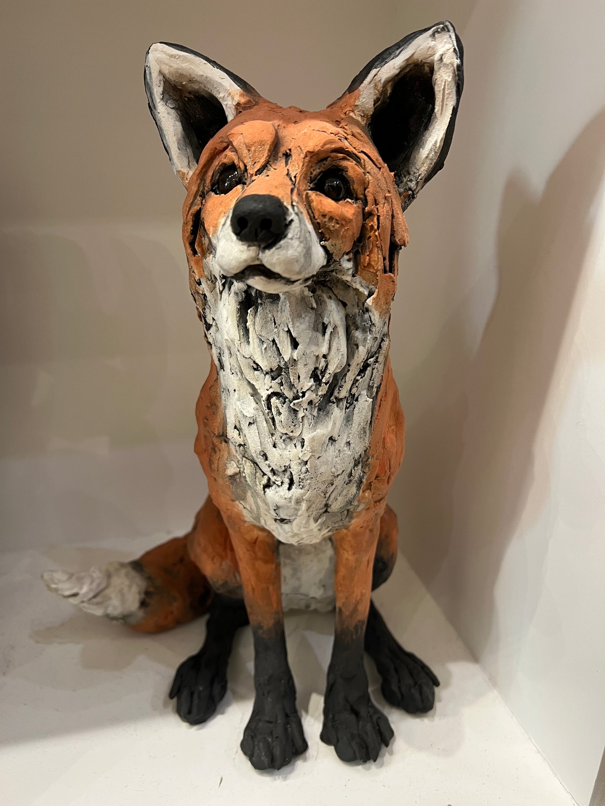 Clay sculpture of a fox on a white surface by Louise Brown at The Acorn Gallery in Pocklington. Call 01759 307652. 