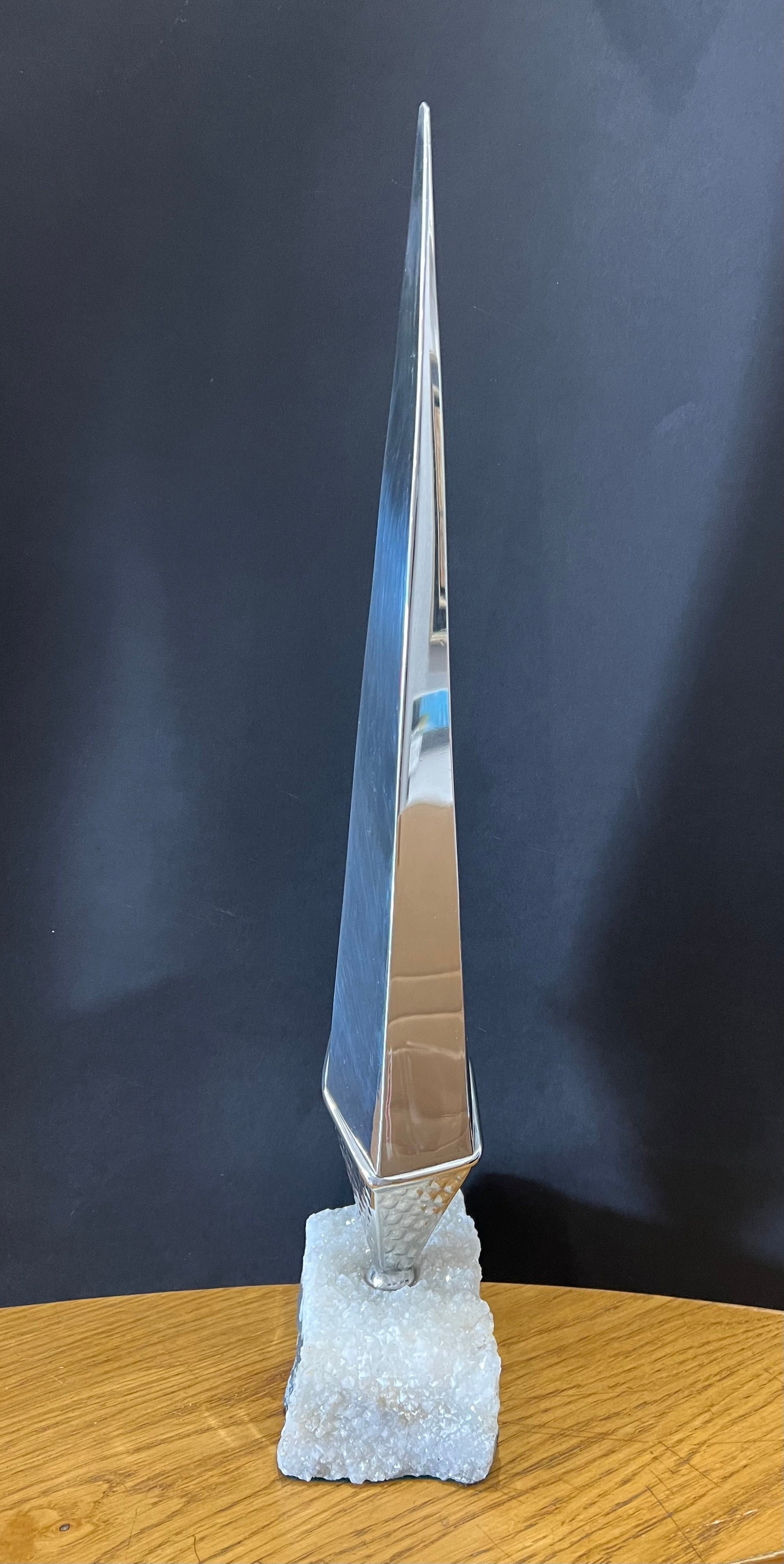 tall stainless steel obelisk mounted on a fine looking piece of rock. Sculpture by Lancastrian sculptor Malcolm Hull and available at The Acorn Gallery in Pocklington. Call 01759 307652.