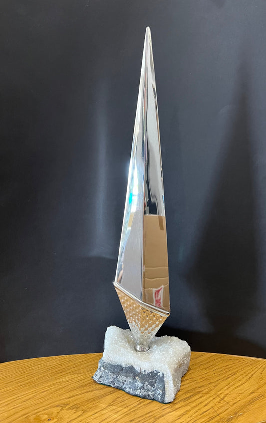 tall stainless steel obelisk mounted on a fine looking piece of rock. Sculpture by Lancastrian sculptor Malcolm Hull and available at The Acorn Gallery in Pocklington. Call 01759 307652.