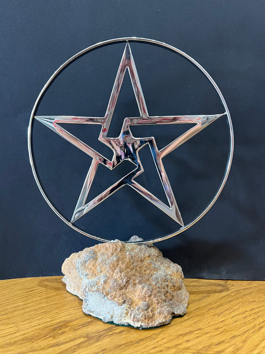 Stainless steel star in a stainless steel ring mounted on a fine looking piece of rock. Sculpture by Lancastrian sculptor Malcolm Hull and available at The Acorn Gallery in Pocklington. Call 01759 307652.