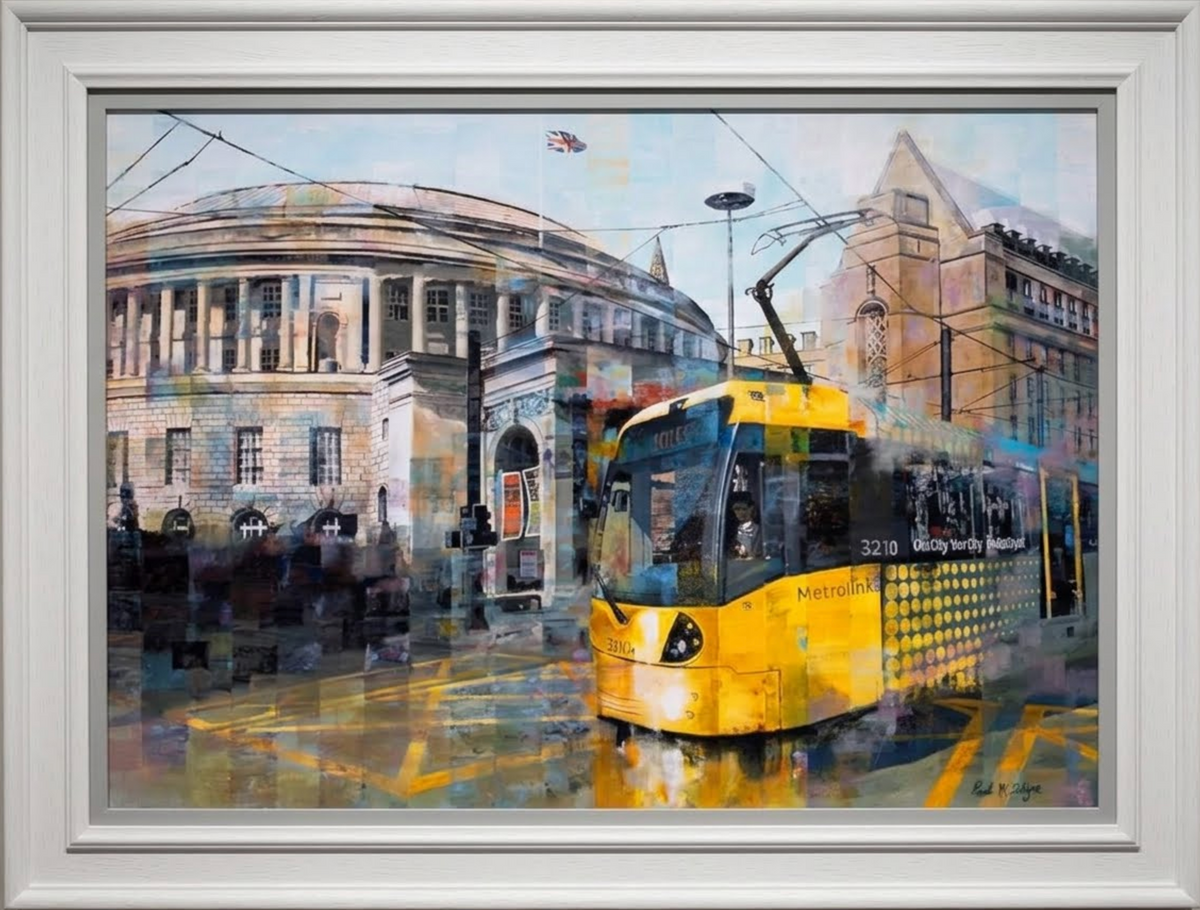 Limited edition print by Paul McIntyre, featuring a bright yellow tram amid Manchester’s historic cityscape, in a white frame.