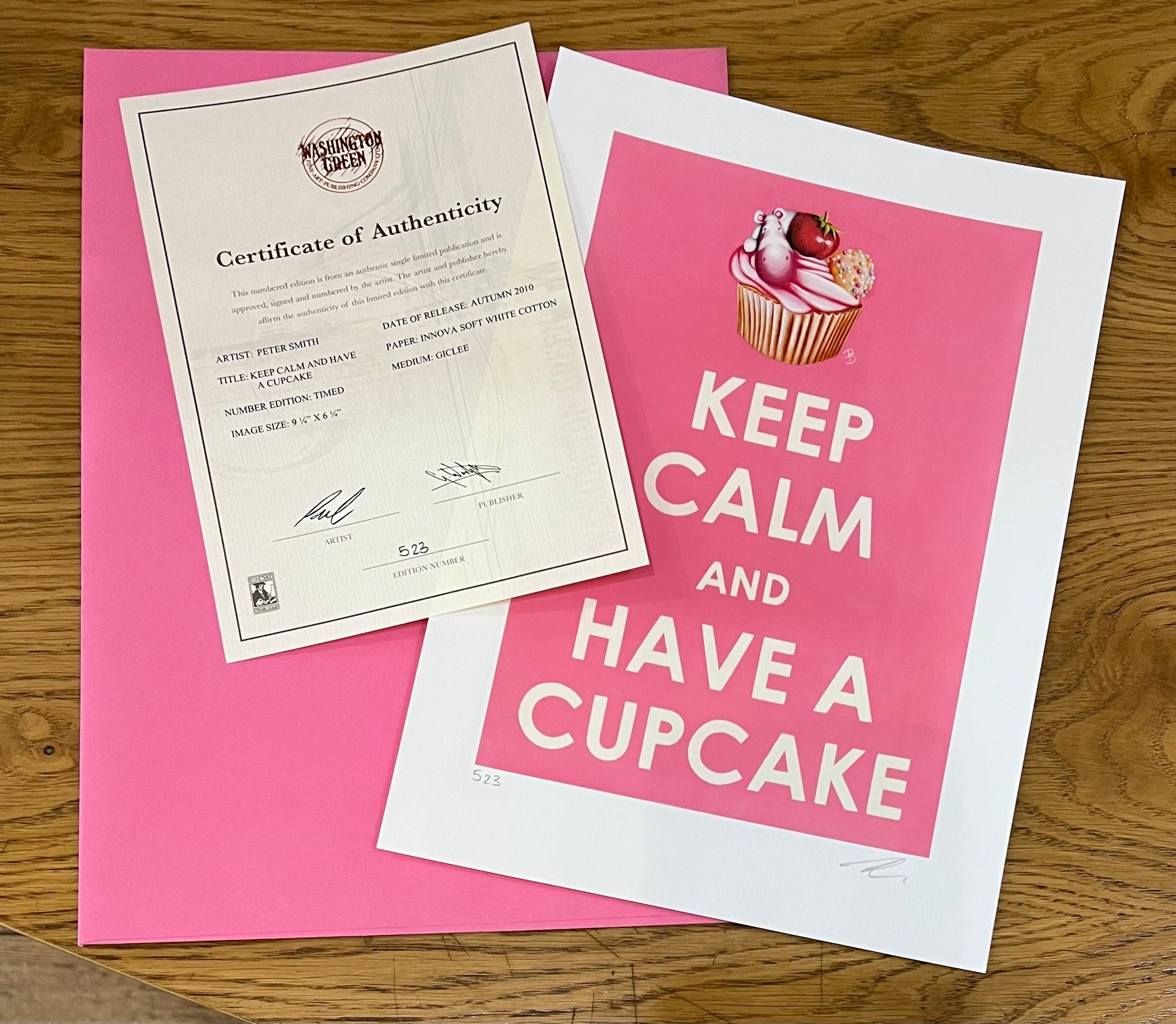 Certificate of Authenticity and 'Keep Calm and Have a Cupcake' print on pink paper by artist Peter Smith.
