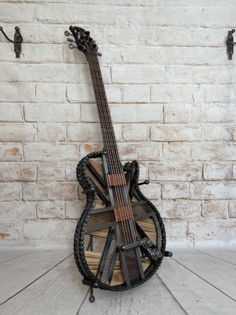 Colours Union Jack metal guitar sculpture by Paul Southwell, inspired by a Gibson Les Paul with heat-tempered iridescent metal and wood detailing
