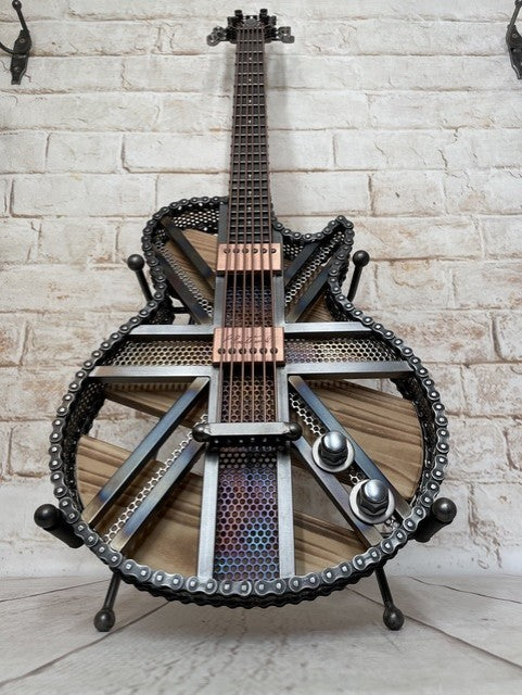Colours Union Jack metal guitar sculpture by Paul Southwell, inspired by a Gibson Les Paul with heat-tempered iridescent metal and wood detailing