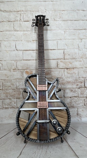 Colours Union Jack metal guitar sculpture by Paul Southwell, inspired by a Gibson Les Paul with heat-tempered iridescent metal and wood detailing