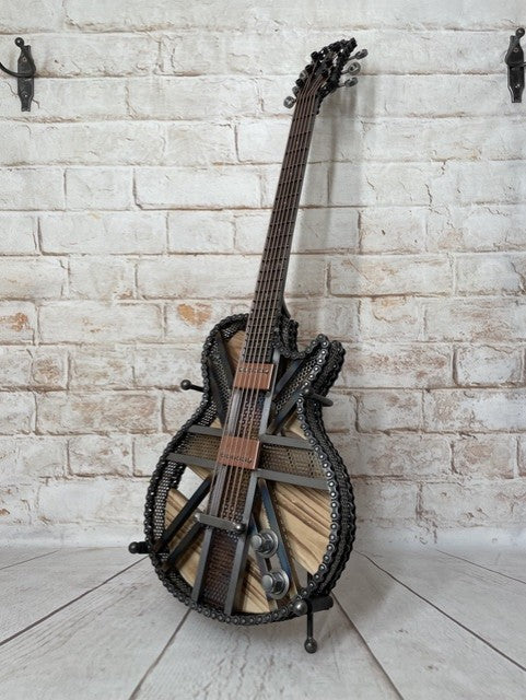 Colours Union Jack metal guitar sculpture by Paul Southwell, inspired by a Gibson Les Paul with heat-tempered iridescent metal and wood detailing