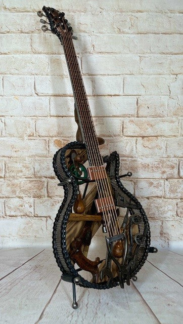 Discover Dad's Old Shed by Paul Southwell, a handmade Les Paul-inspired metal guitar sculpture created using old tools. Available at The Acorn Gallery, Pocklington