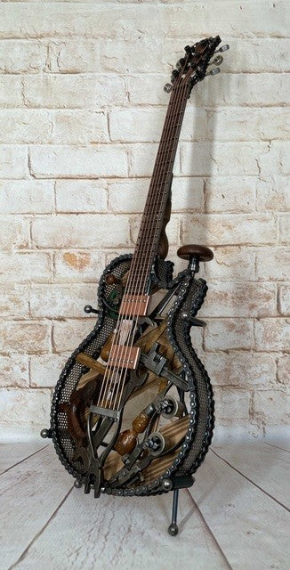 Discover Dad's Old Shed by Paul Southwell, a handmade Les Paul-inspired metal guitar sculpture created using old tools. Available at The Acorn Gallery, Pocklington