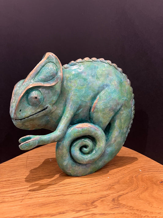 Bronze chameleon sculpture by Roxy Winterburn, with mottled turquoise patina, curled tail and textured scales