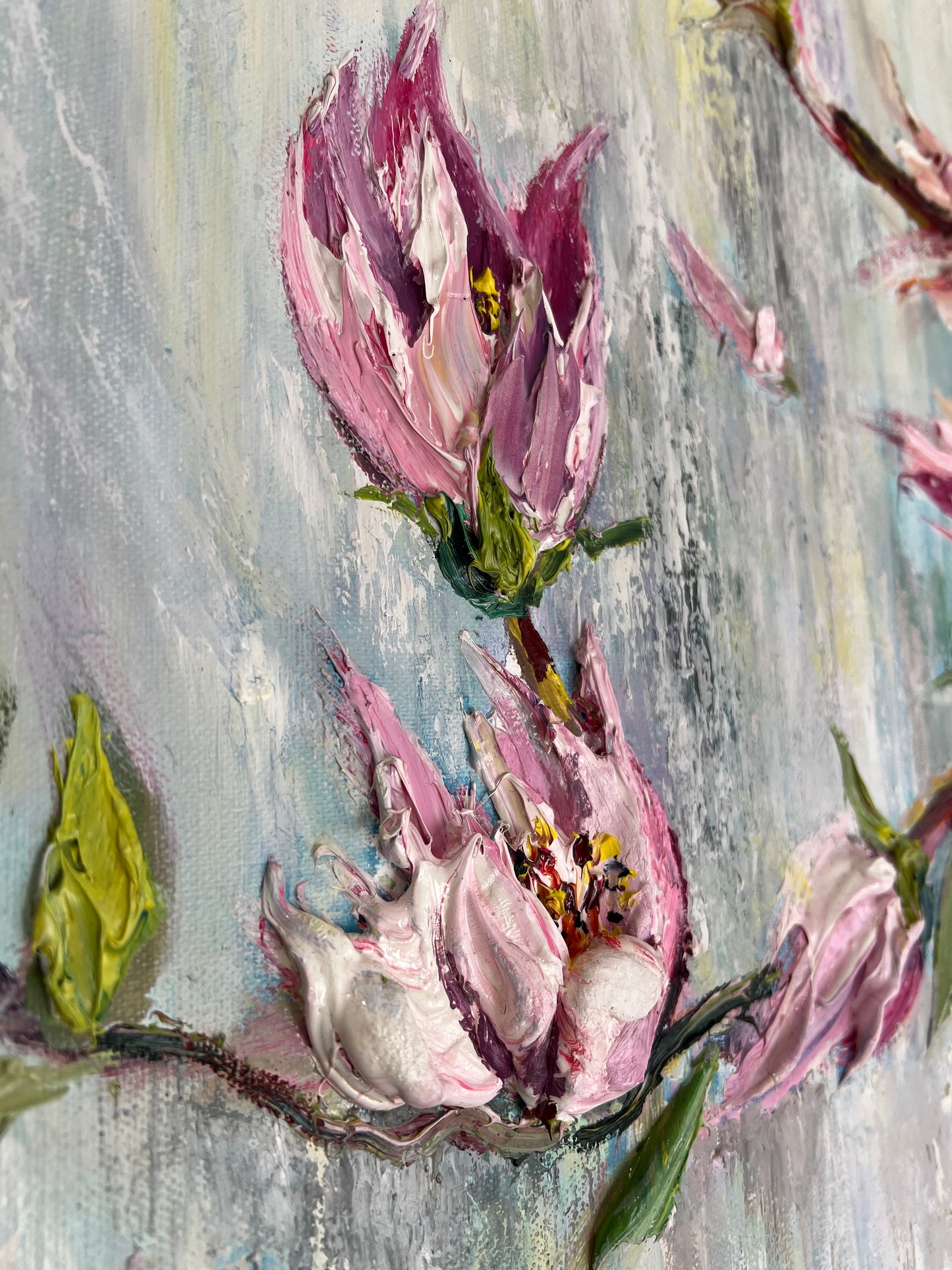 Original textured painting of delicate pink magnolia blossoms against a soft pastel blue and lavender background, created with expressive impasto brushwork by Yulia Lisle. Painting available from The Acorn Gallery in Pocklington. Visit us or Shop online or Call 01759 307652. 