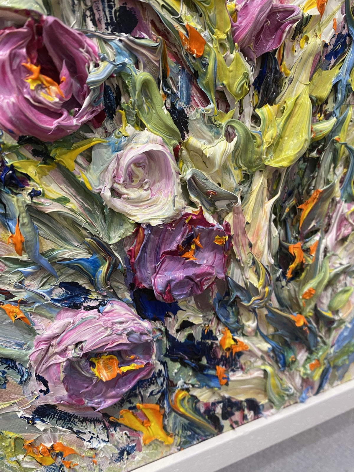 Close Up of Emotions an original floral painting by Yulia Lisle featuring richly textured pink, purple, white and yellow flowers in a white frame.