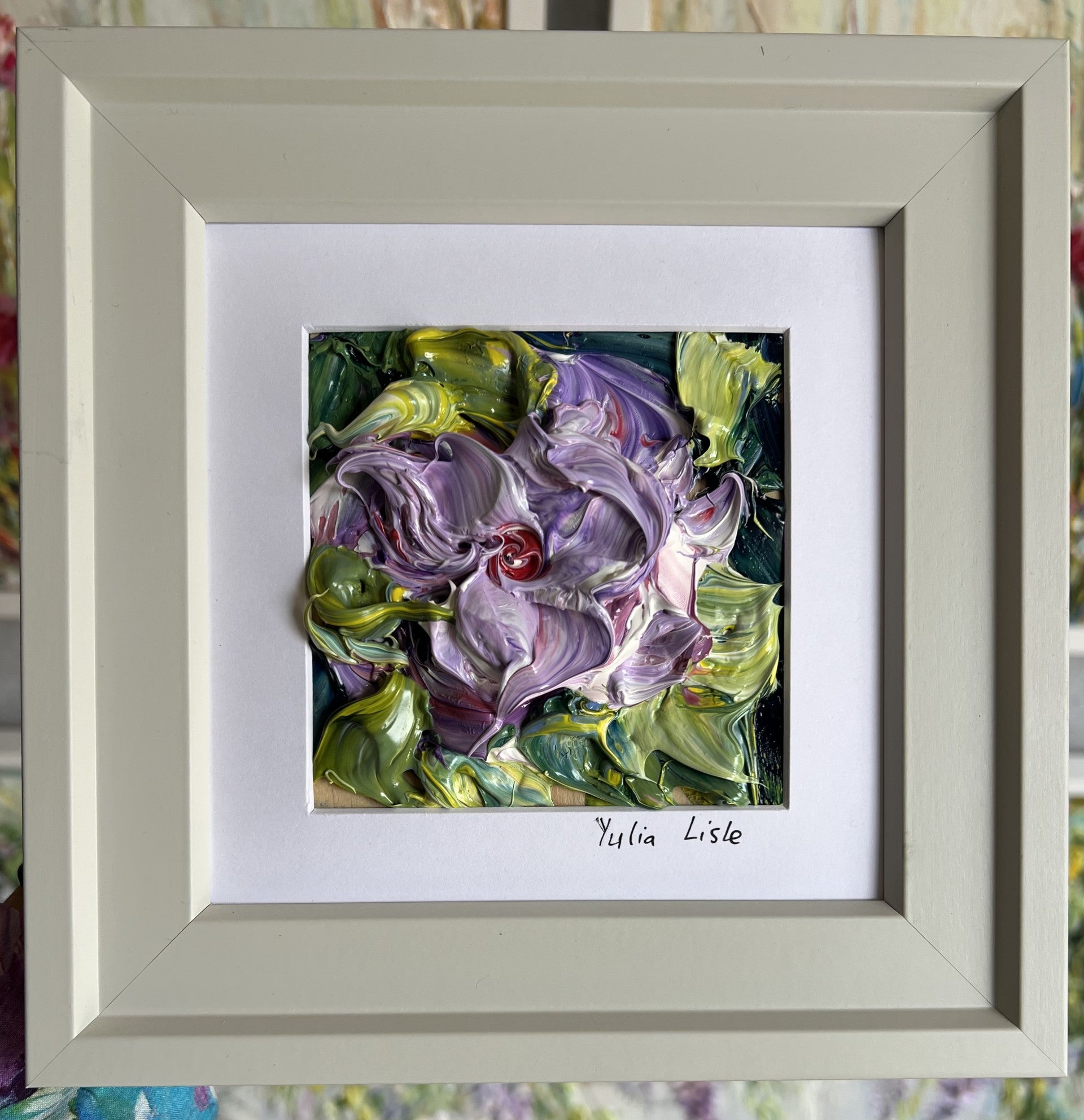 Small framed original oil painting featuring a richly textured lilac flower surrounded by green foliage, created with thick expressive impasto paint by Yulia Lisle. Available at The Acorn Gallery in Pocklington. Shop online or Call Us on 01759 307652. 