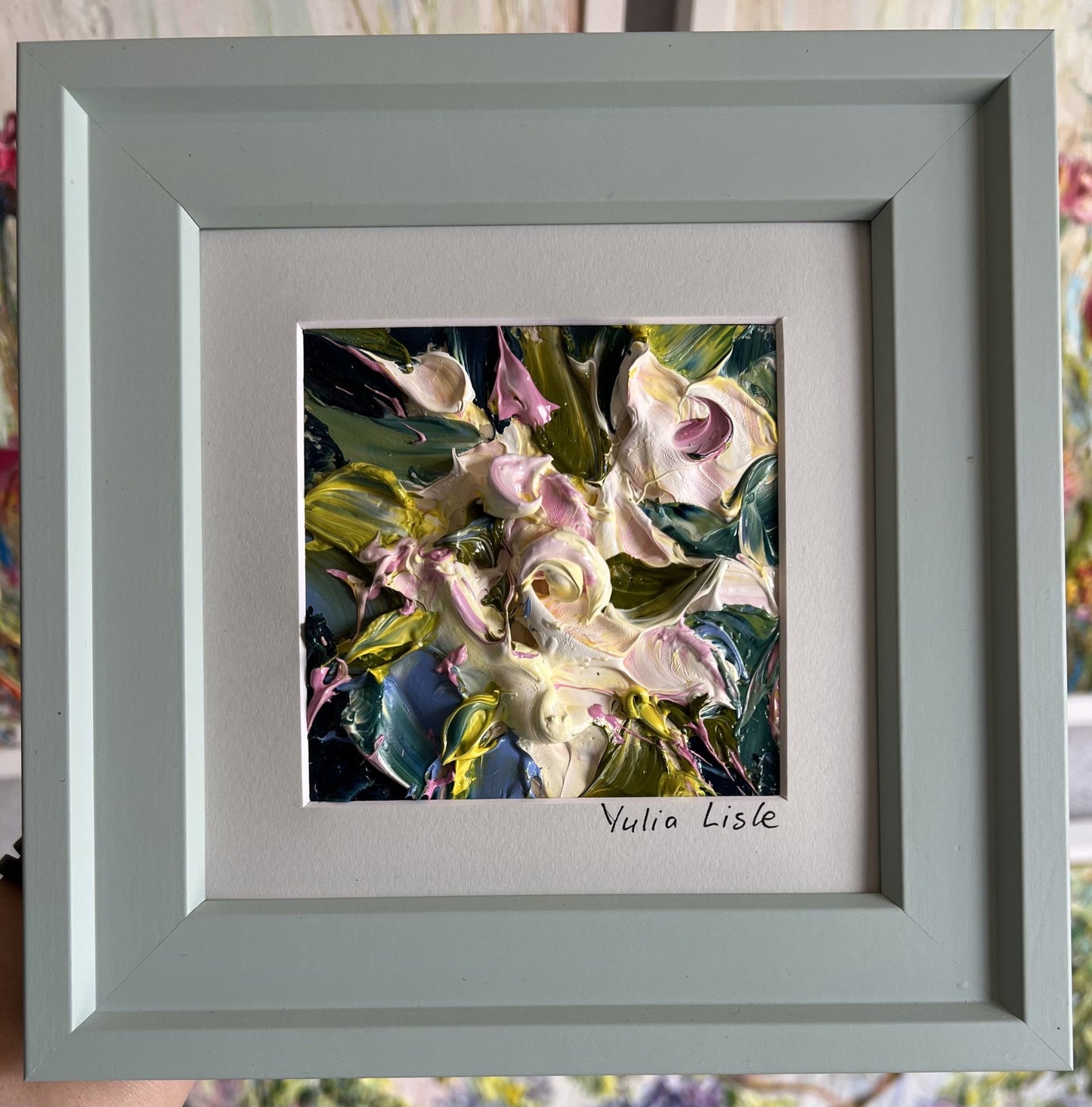 Small framed original impasto oil painting by Yulia Lisle featuring soft cream and blush flowers surrounded by rich green foliage, created with heavily textured palette knife strokes. Artwork by Yulia Lisle and available at The Acor Gallery in Pocklington where you can shop online or call us on 01759 307652. 