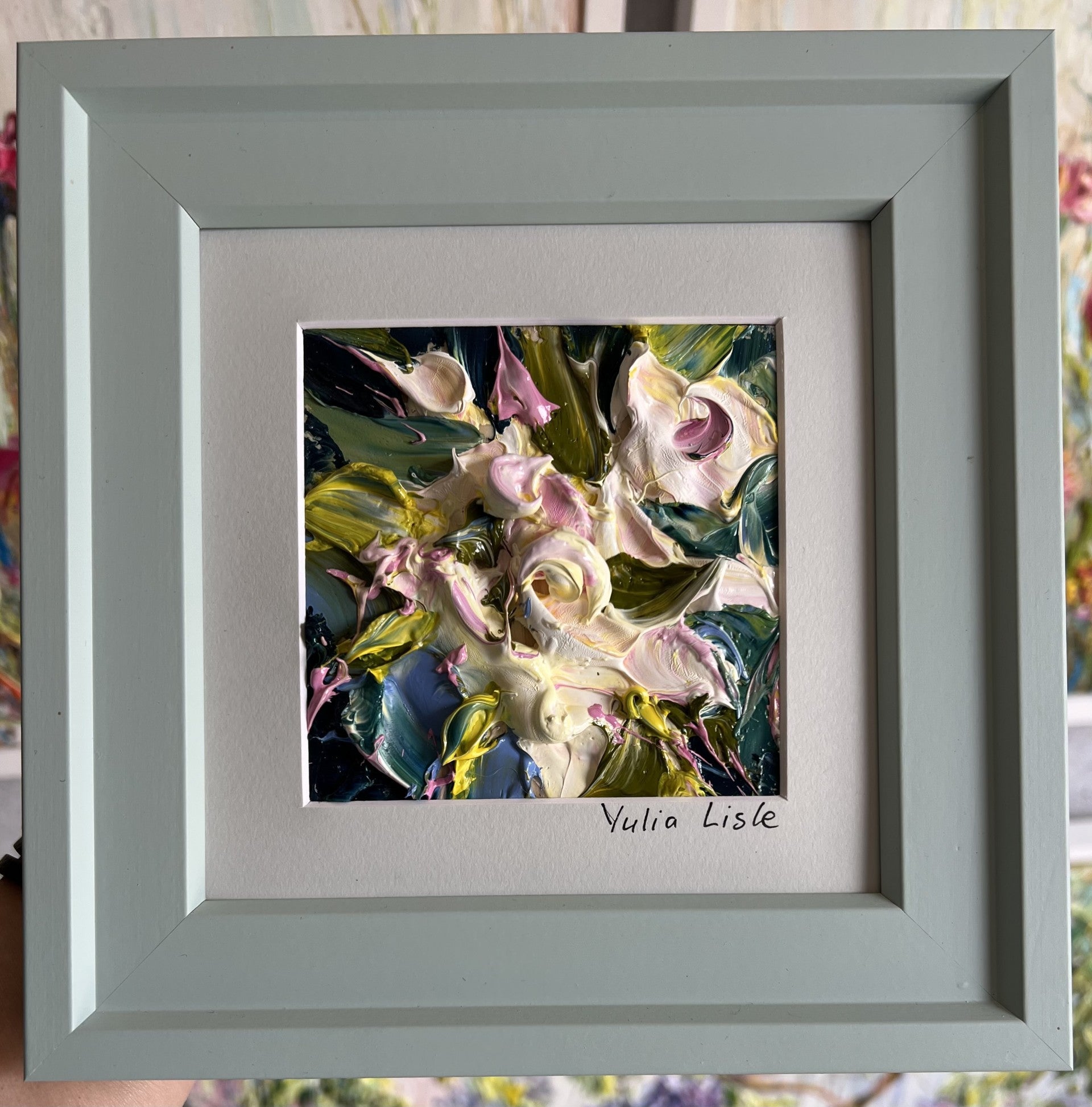 Small framed original impasto oil painting by Yulia Lisle featuring soft cream and blush flowers surrounded by rich green foliage, created with heavily textured palette knife strokes. Artwork by Yulia Lisle and available at The Acor Gallery in Pocklington where you can shop online or call us on 01759 307652. 