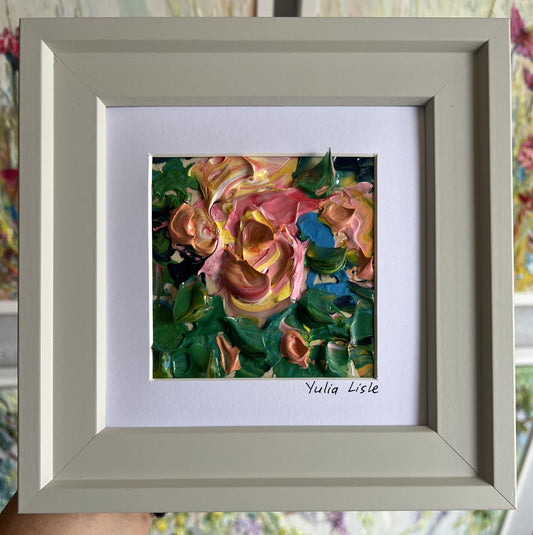 Small framed original impasto oil painting by Yulia Lisle featuring a softly textured pink flower surrounded by lush green foliage, painted with expressive palette knife strokes and rich layers of oil paint. Artwork by Yulia Lisle and available at The Acorn Gallery in Pocklington where you can shop online or call us on 01759 307652.