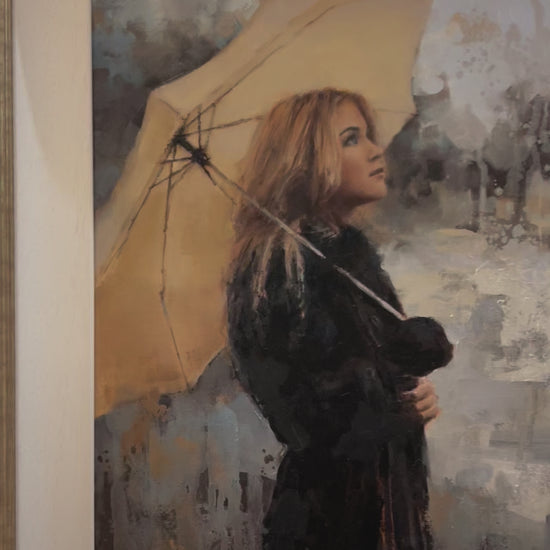 Vanilla Snowdrop by Tony Hinchliffe, a beautiful limited edition canvas print of a young woman with blonde hair in a dark coat holding a cream umbrella. Available from The Acorn Gallery in Pocklington. Order online or call us on 01759 307652. 