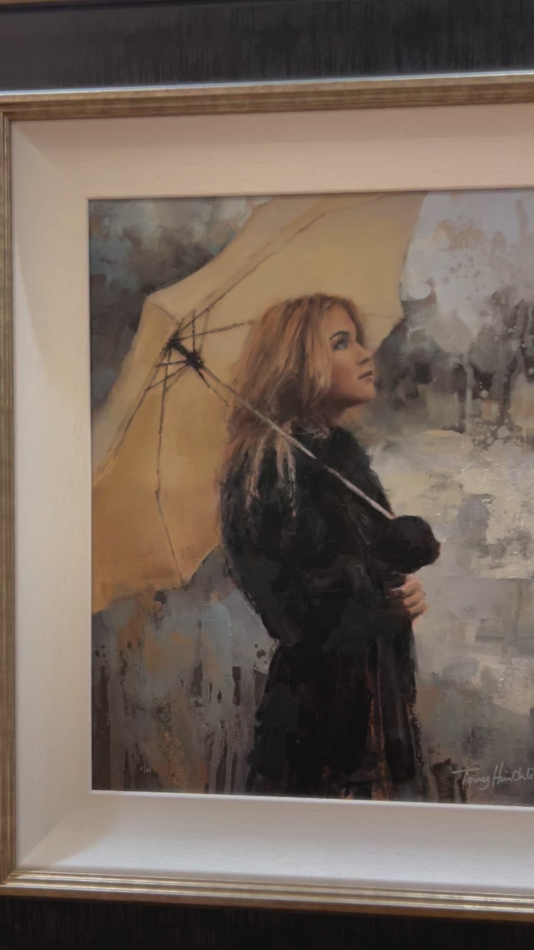 Vanilla Snowdrop by Tony Hinchliffe, a beautiful limited edition canvas print of a young woman with blonde hair in a dark coat holding a cream umbrella. Available from The Acorn Gallery in Pocklington. Order online or call us on 01759 307652. 