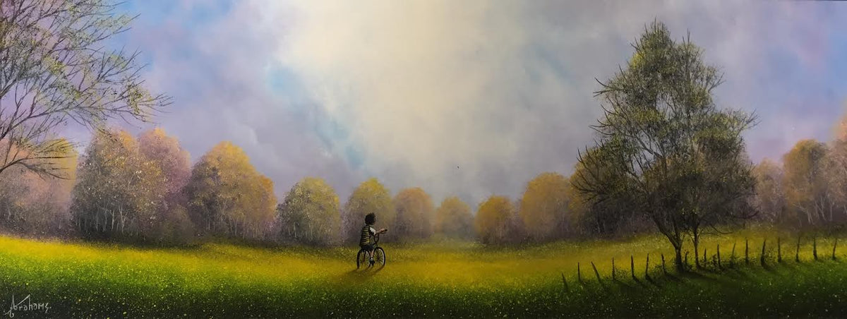 Original oil painting by Danny Abrahams, with a lone cyclist crossing a vivid yellow-green field beneath autumn trees and a pastel sky.
